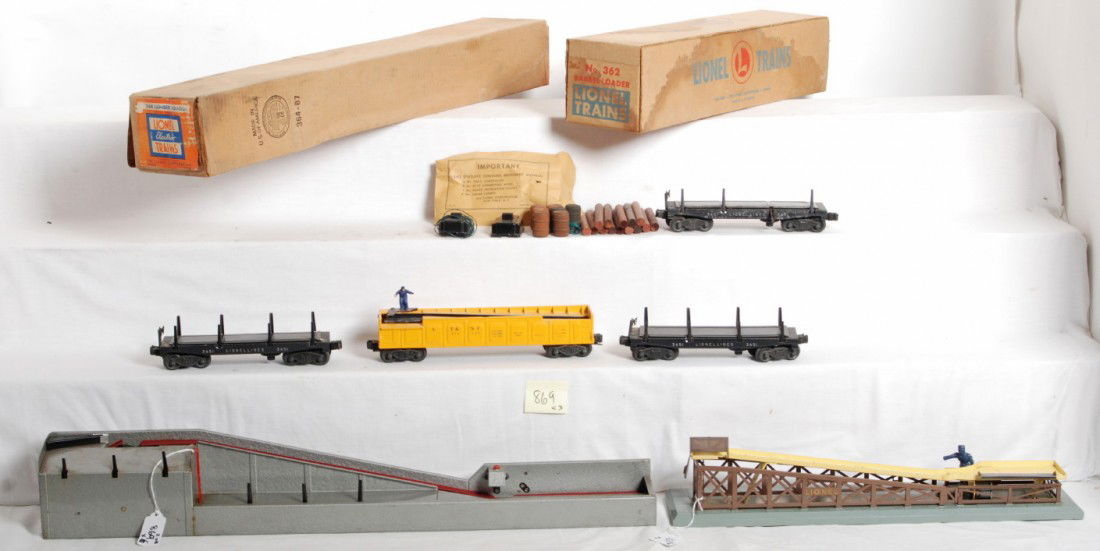 Lionel 362 & 364 in OB, 3451 x3, 3562-50: Postwar Lionel O gauge 362 barrel loader and 364 lumber loader in original boxes with two 364C controllers, 364-92 components envelope. Three 3451 automatic lumber cars (one missing stakes on one side