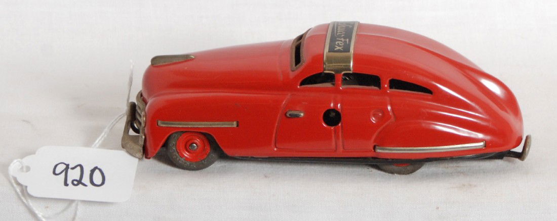 Schuco FEX 1111 U.S. Zone Germany key wind auto: Schuco FEX 1111 four door automobile, key wind tinplate with original rubber tires (no splits), original C8. Car has no key. Automobile measures approximately 5-3/4 inches long. Paint is near 100 perc