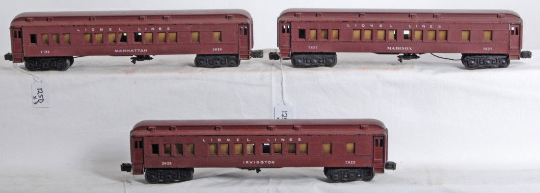 Lionel No. 2625, 2627, 2628 Madison passenger car: Postwar Lionel O gauge No. 2625 Irvington, No. 2627 Madison, and No. 2628 Manhattan, Pullman passenger coaches. 2627 has about a half dozen tiny cream colored paint drips, otherwise trains look C6+.