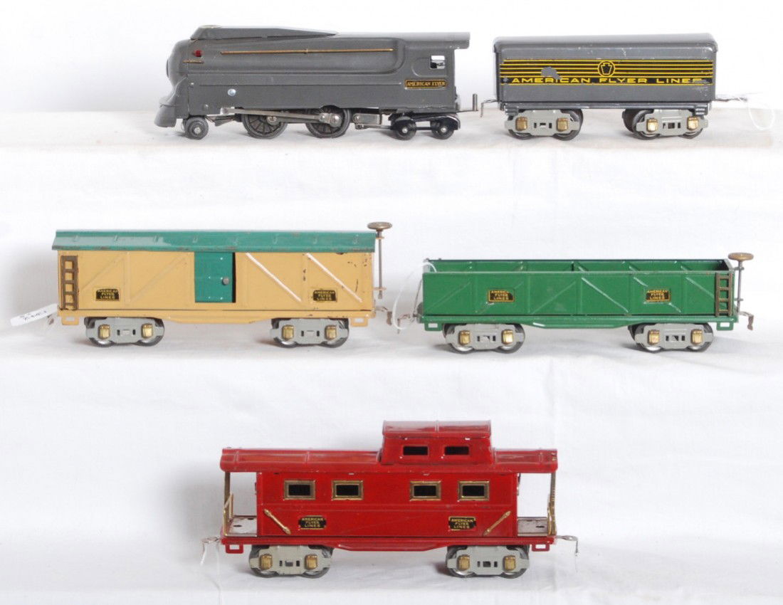 American Flyer streamlined steam loco w/freight: Prewar American Flyer O gauge streamlined steam locomotive and tender with sandcar, boxcar, and a caboose, C6 area. Lead and trailing truck wheels on loco have varying amounts of casting fatigue.