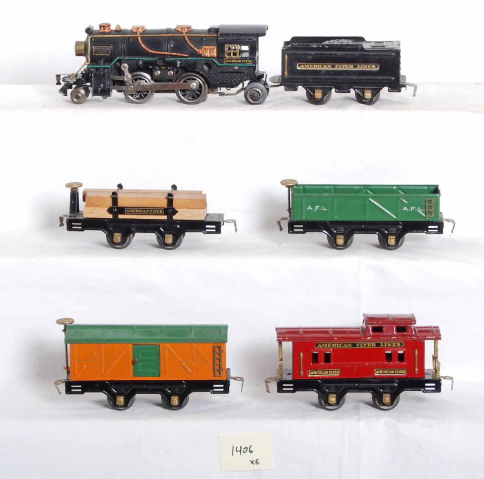 American Flyer loco & tender with four freight ca: Prewar American Flyer O gauge diecast steam loco with tinplate tender, 3306, flatcar with lumber load and original restraints, 3013 sand car, 3012 boxcar, 3014 caboose. Trains are clean C6 area.