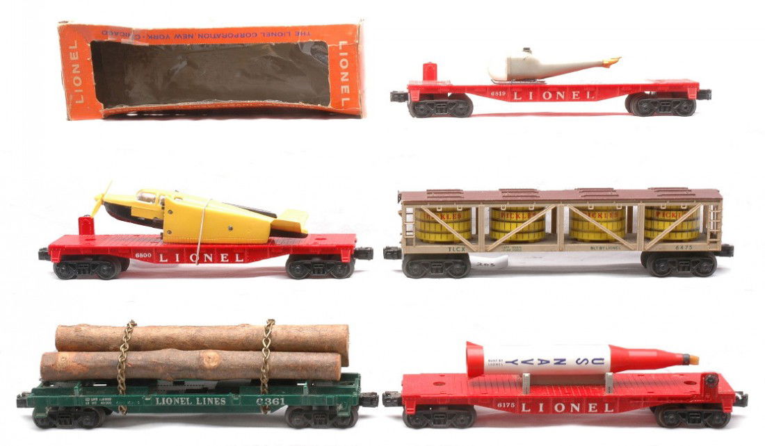 Lionel Postwar Freights 6800 6361 6819 6175 6475: Lionel postwar freight cars including; 6800 flatcar with airplane that is yellow over black in a reproduction box, 6361 green flatcar with lumber load, 6819 flatcar with a broken helicopter in a worn