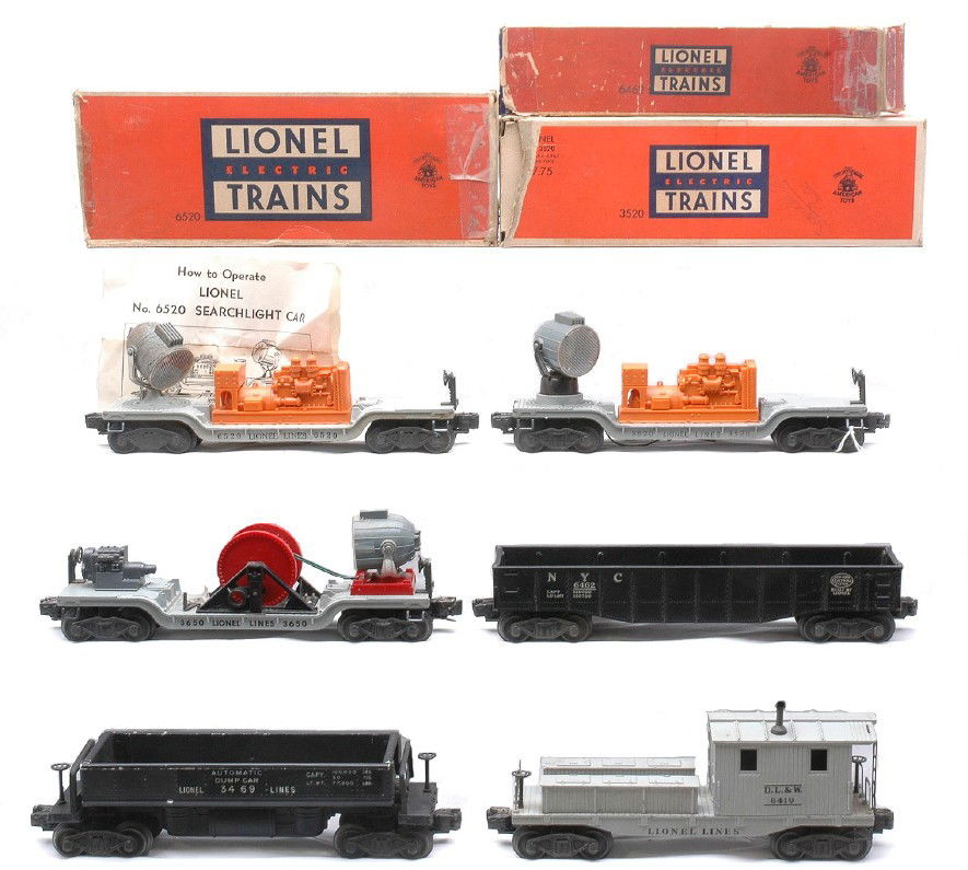 Lionel Freights 6462 3520 6520 w/OBs 3650 6419: Lionel postwar freight cars including; 6462 black New York Central gondola, 3520 operating searchlight, 6520 searchlight car with instruction sheet in OBs, a 3650 searchlight and a 6419 D.L.& W. work