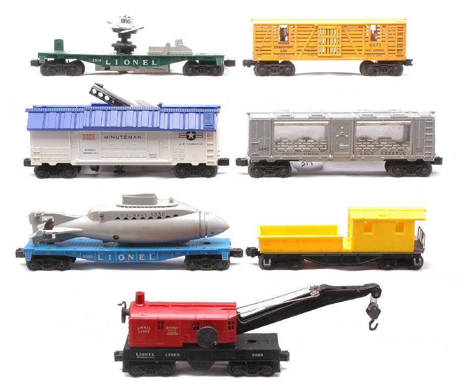 Lionel 6445 6473 3665 3519 3330 6530 6120: Lionel postwar freight cars including; 6445 Fort Knox car, 6473 horse transport car, 3665 Minuteman rocket launcher, 3519 satellite launching car, 3330 flatcar with a 3830 U.S. Navy submarine, a 6530 