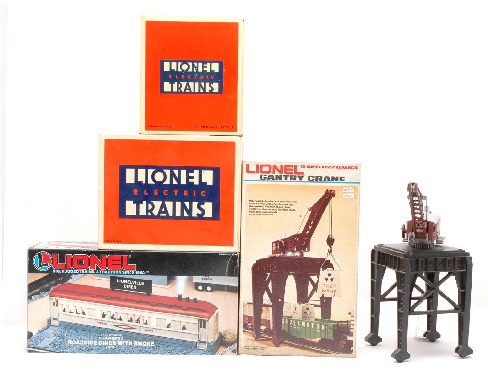 Lionel Accessories 12722 12835 12768 2302 OBs.: Lionel accessories including; 12722 roadside diner with smoke, 12835 fueling station, 12768 burning switch tower and a 2302 gantry crane all in OBs. The accessories have shelf dust and are C8.