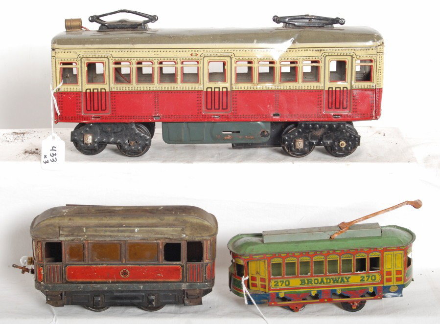 Three tinplate trolleys G.C. Co., Japanese: Three tinplate toy trolleys. Two are Japanese; one is mechanically powered with battery powered illumination and the other is a Broadway 270 with no other markings. Third is marked G.C. Co. No. 48 and