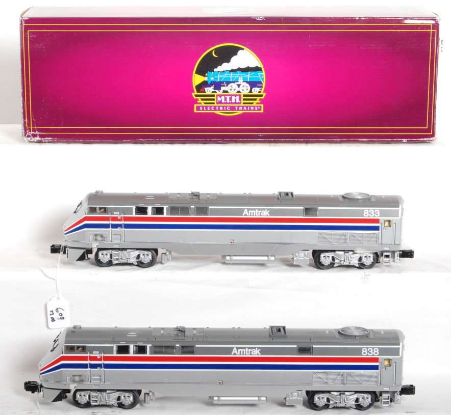 MTH Amtrak Genesis power and dummy pair Proto 2: MTH modern O Gauge Amtrak Genesis pair in OBs. One is powered and the second is a dummy. Catalog numbers are 20-2722-1 and 20-2722-3. Powered unit features DCS control, Protosound 2.0, Protosmoke, Pro