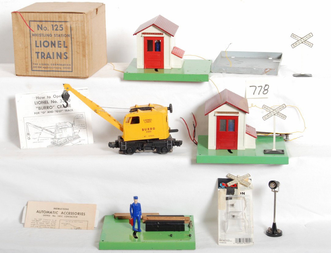 Lionel 125, 145, 70, 1047, 3360: Lionel Postwar O Gauge accessories and operating burro crane. Includes two 145 operating gate men, 70 yard light, 1047 operating watchman with flag, 125 whistling station with OB, packet and instructi