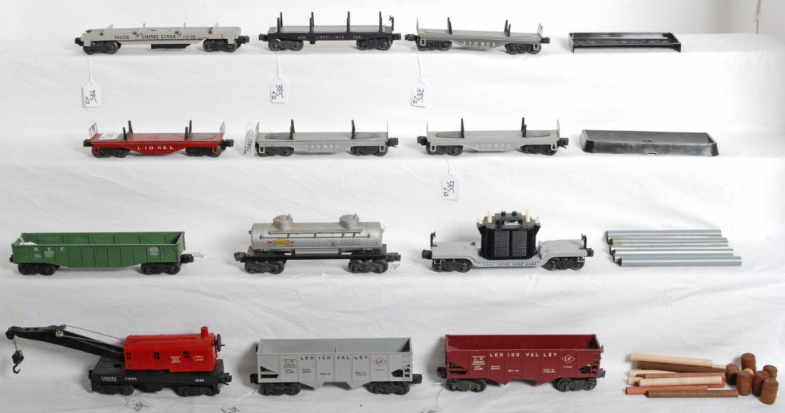 Lionel 3361, 6560, 3451, 6462, 6456, 6456, 2461...: Postwar Lionel O gauge freight cars. 3361 flatcar, 6560 operating work crane, 3451 automatic lumber car, 6462 New York Central gondola, two 6456 Lehigh Valley hoppers, four unnumbered metal lumber/pip