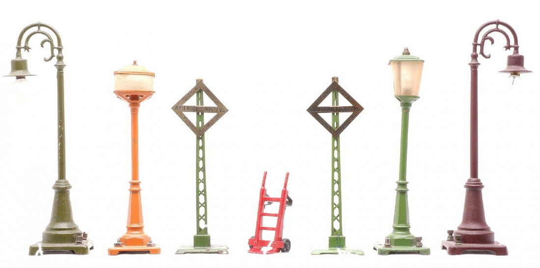 Lionel Accessories 157 56 57 59 59 068 068: Lionel prewar O gauge accessories including; 157 red hand truck, 56 pea green lamp post, 57 orange lamp post with street names, two 59 lamp posts, one olive green and a restored maroon one and two 068