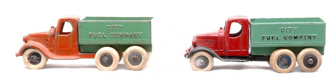 TootsieToy 0804 Mack City Fuel Co. Coal Trucks: TootsieToy two 0804 Mack City Fuel Company coal trucks with ten wheels. One of the trucks is red and green and the other one is orange and green. The trucks are C7.