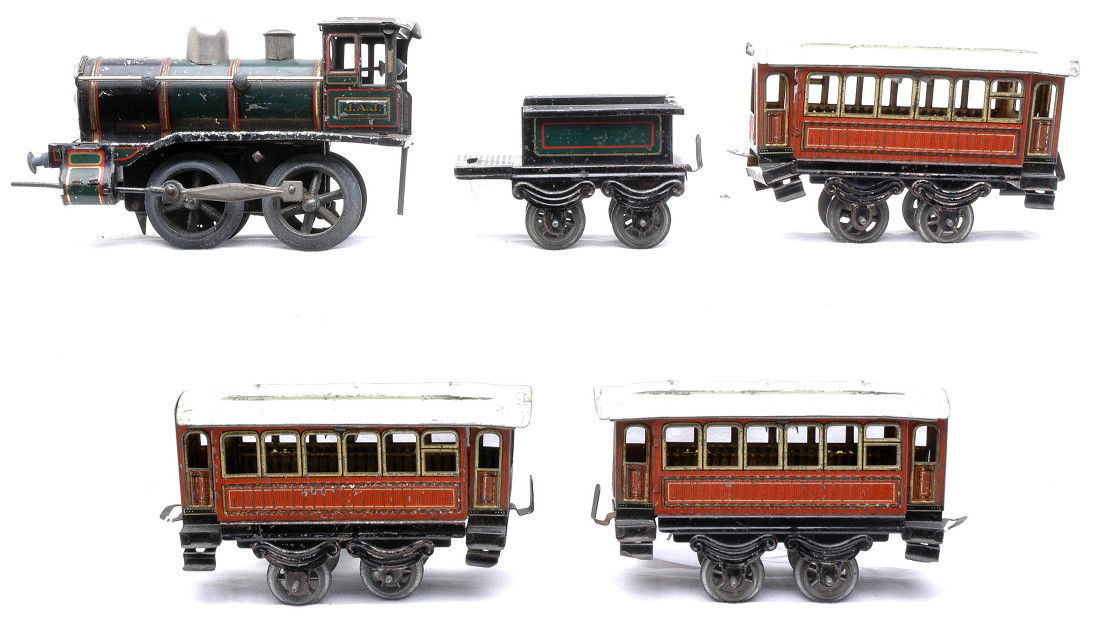 Issmayer Litho Pass Set Loco Tender 2 Coaches: Issmayer O gauge lithographed tin plate passenger set including; green/gold/red/black clockwork 0-4-0 steam loco lettered J.A.J. with tender and three red four wheel coaches with white roofs The loco