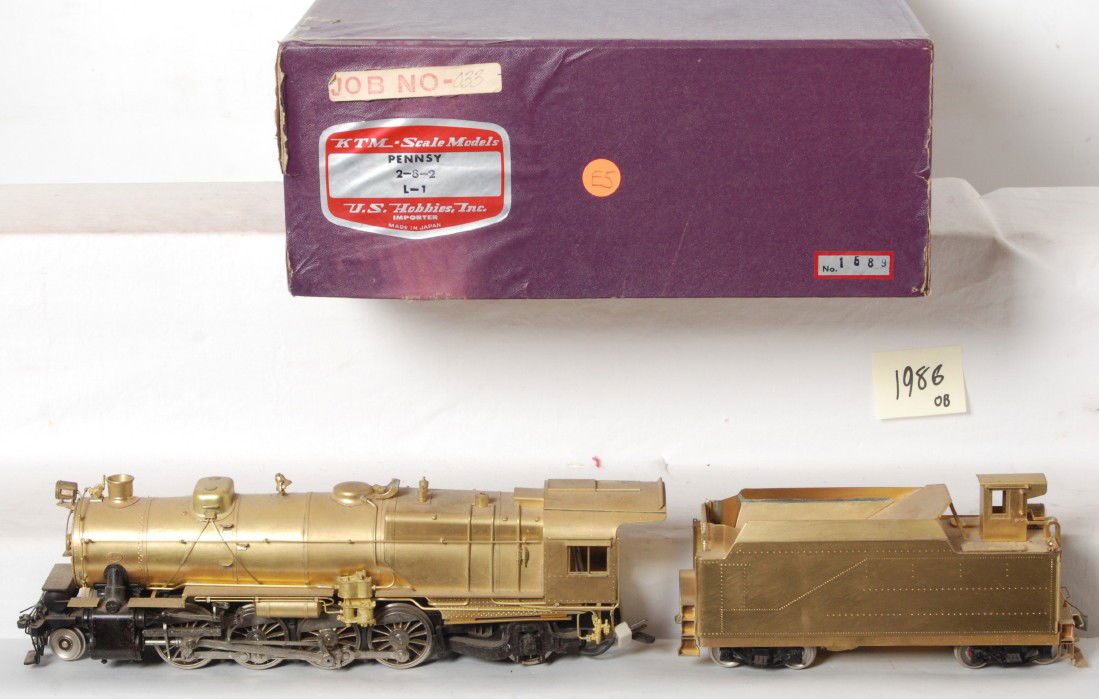 KTM Pennsylvania 2-8-2 steam locomotive: KTM O scale two rail Pennsylvania 2-8-2 L-1 steam locomotive in OB. KTM serial number is 1689. Loco is C7-8 with some light spotting and display along the top. OB has some fading and worn corner. See