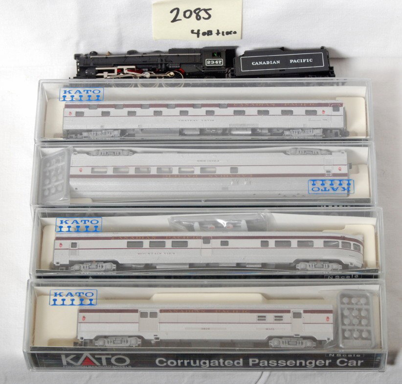 Canadian Pacific loco and 4 Kato passenger cars: Trix and Kato modern N scale. Includes Trix Canadian Pacific 4-6-2 loco and four Kato passenger cars. Cars are Kadee couplers and loco is hook style. Overall C8 condition.