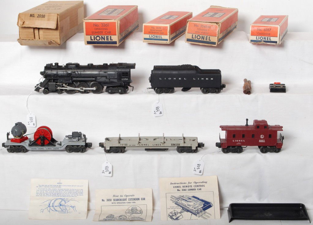 Lionel 2056, 2046W, 3361, 3650, 6357 in OB: Postwar Lionel O gauge 2056 steam locomotive, 2046W whistle tender, 3361 operating lumber car, 3650 searchlight extension car, and 6357 illuminated caboose. Trains look nicer clean C6, loco has touchu