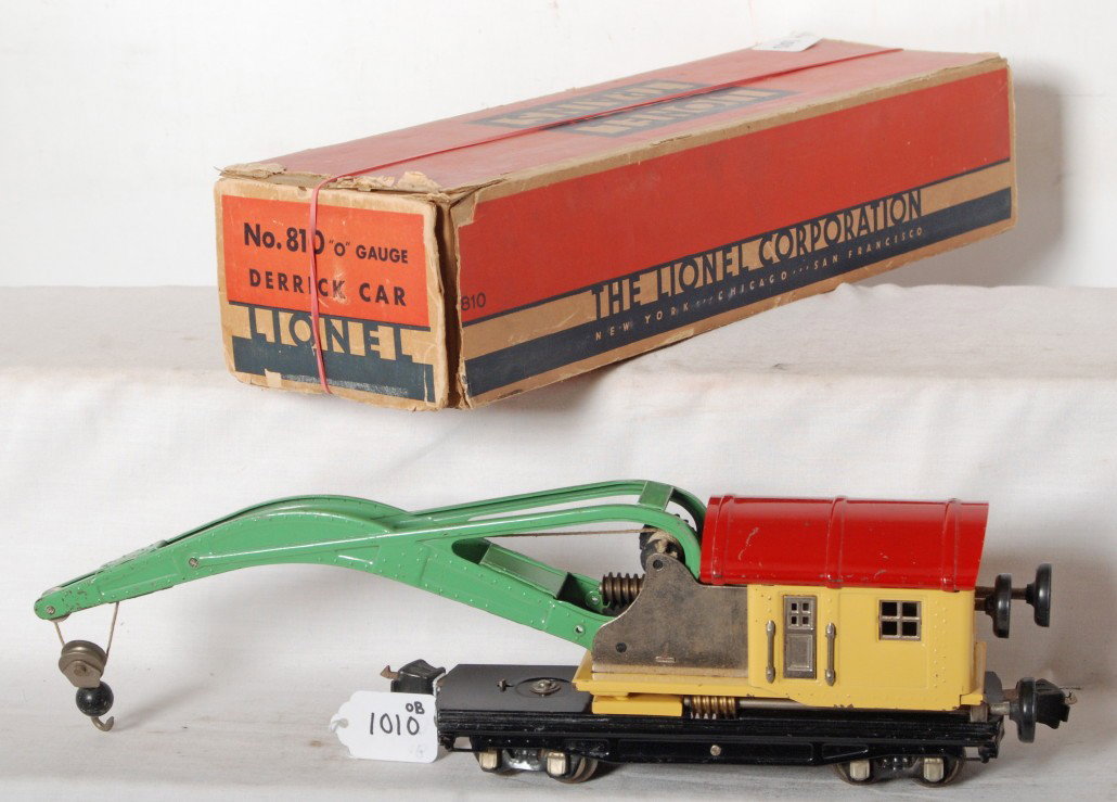 Lionel No. 810 derrick car in yellow in OB: Prewar Lionel O gauge No. 810 operating derrick car in original box with insert. Train is in yellow and looks very clean and shiny C6+. Box has missing and detached flaps.