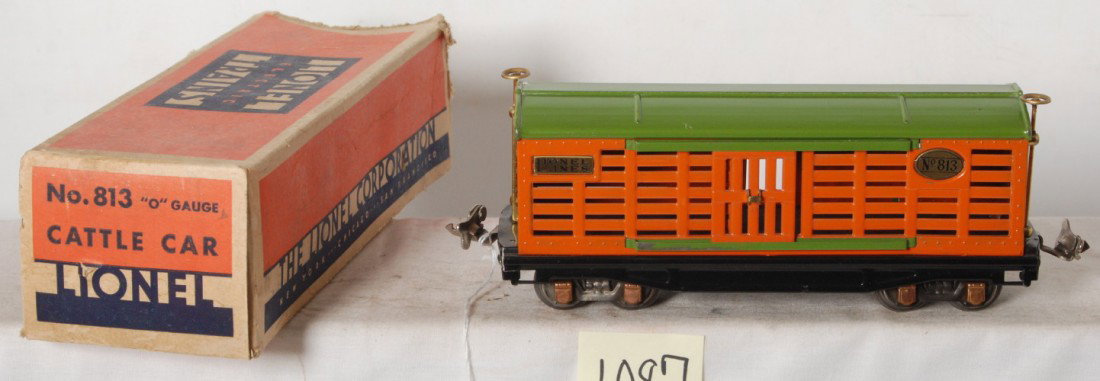 Lionel No. 813 cattle car in OB: Prewar Lionel O gauge No. 813 cattle car in orange and pea green, very high C6+. Super clean and shiny. Box is missing flaps on one end.