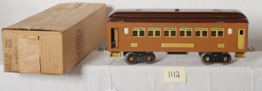 Lionel No. 309 Ivory/Brown Pullman in OB: Prewar Lionel standard gauge No. 309 Pullman in Ivory/Brown, low C7. Very clean and shiny car. Box is very square and solid with nice printing and no missing flaps.