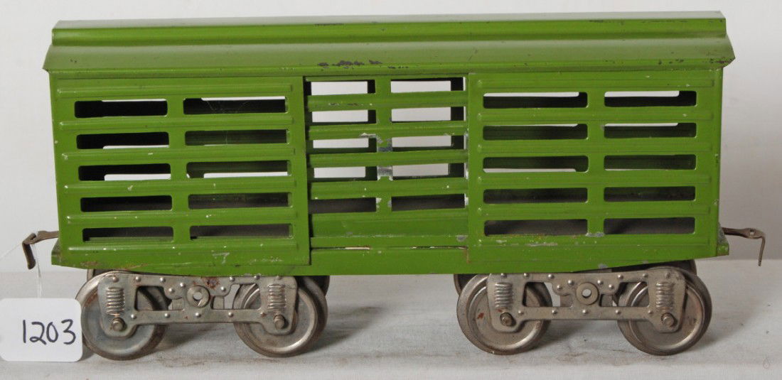 Lionel No. 13 cattle car one piece roof, no brake: Prewar Lionel standard gauge unnumbered cattle car in pea green with one piece roof, five slats in doors and sides, no brake wheels, rubber stamped info on underside of frame. Train is nice clean and