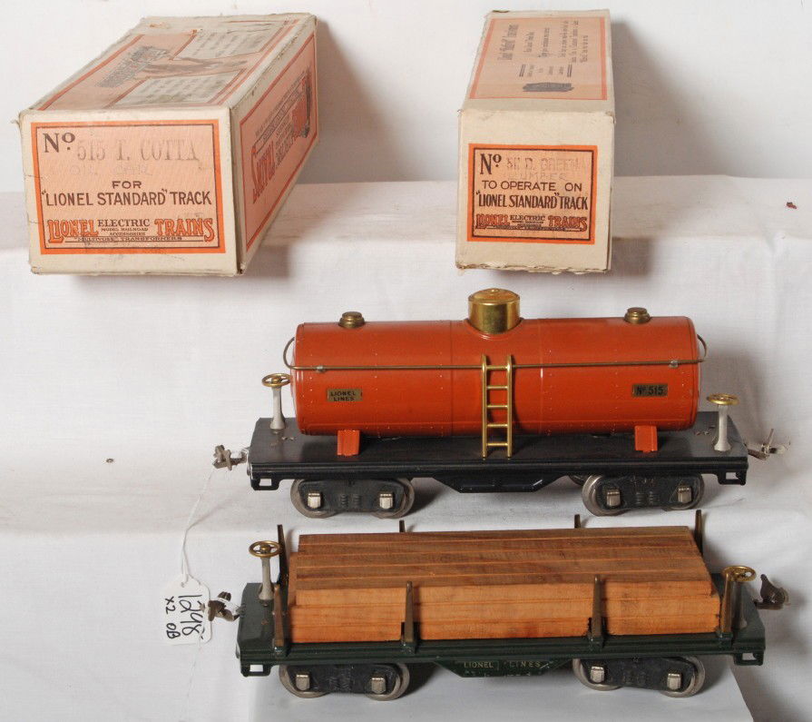 Lionel prewar SG 515 tank and 511 flat in boxes: Lionel prewar standard gauge 515 tank car in terra cotta with mixed trim, nice C8+, OB C7. 511 flatcar with lumber, C7, OB missing flaps on one end.