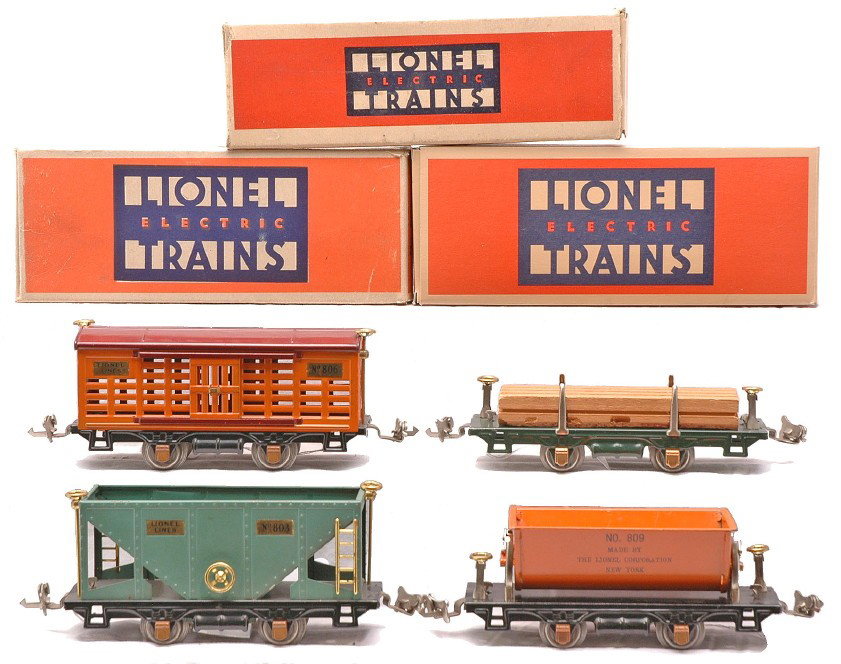 Lionel Four Wheel Freights 803 806 809 831: Lionel prewar O gauge four wheel freight cars; 803 peacock hopper, 806 orange cattle car with maroon roof, 809 orange dump car and 831 dark green flatcar with wood load all in OBs, except for the 803.