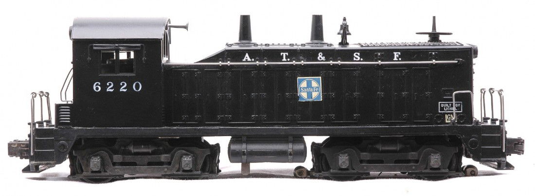 Lionel Postwar 6220 Santa Fe NW2 Switcher: Lionel postwar 6220 Santa Fe NW2 bell ringing switcher with a small GM decal. The bottom of the unit has some corrosion. The switcher is C7.