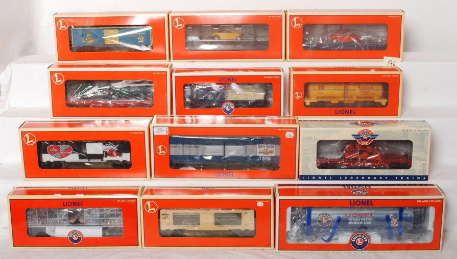 12 Lionel freight cars 19444, 39202, 26023, etc.: Lionel modern O gauge freight cars in OBs. Twelve cars include 17522 flat with Prowlers, 19444 flat with VW bugs, 39202 centennial boxcar, 17534 Diamond T flat, 36556 Lionel Lines work caboose, 16188 