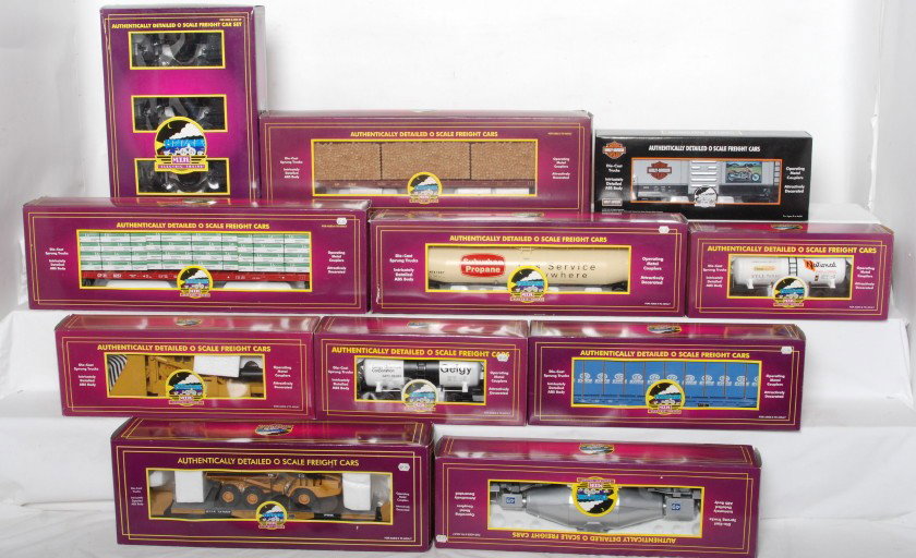 13 MTH premier freight cars 90011, 96015, 98202: MTH modern O gauge freight cars in OBs. Thirteen cars include 93223 Harley boxcar, 90011 three car slag set, 98229 CP Rail I beam, 98205 Union Pacific Jordan spreader, 96004 National Starch tank car, 