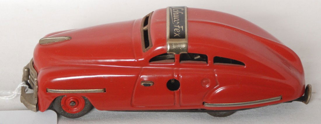 Schuco FEX 1111 U.S. Zone Germany key wind auto: Schuco FEX 1111 four door automobile, key wind tinplate with original rubber tires (no splits), original C8. Car has no key. Automobile measures approximately 5-3/4 inches long. Paint is near 100 perc