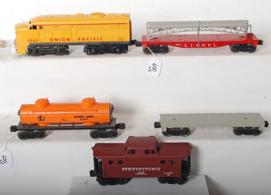 Lionel 1065, 6825, flatcar, 6465, 6437: Postwar Lionel O gauge 1065 Union Pacific diesel Alco A unit, 6825 flatcar w/bridge section, unnumbered flatcar, 6465 tank, and 6437 Pennsylvania caboose, C6 area.