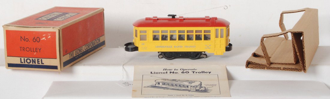 Lionel 60 blue letter two piece bumper trolley in : Postwar Lionel O gauge No. 60 trolley, blue letter and two piece bumper variant, nice clean and bright C7. A little surface rust starting to form on a bumper. Box has some tears/wear to flap folds, ot