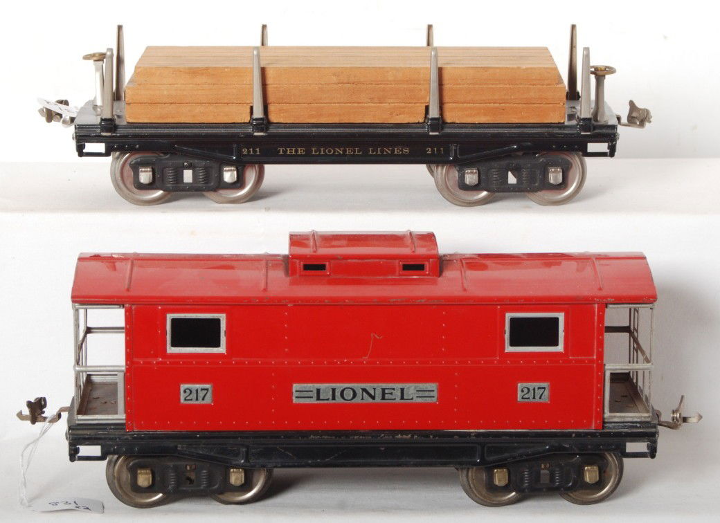 Lionel standard gauge freight cars, 211 and 217: Prewar Lionel standard gauge No. 211 flatcar with lumber load and No. 217 caboose, C6-7.