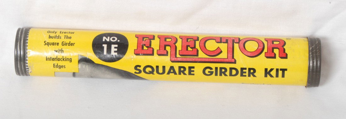 Gilbert Erector 1E square girder kit: Gilbert Erector No. 1E square girder kit in original tube. Kit is C7-8 area and looks complete Tube shows light handling marks and price sticker on end. Tube is C7-8, light wear at one edge.