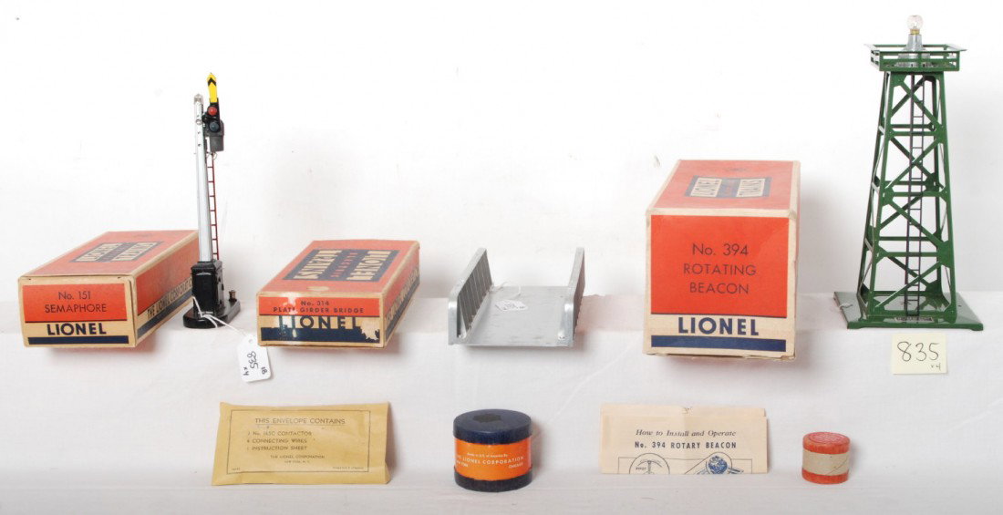 Lionel boxed accessories. 151, 314, 394, and 3927-: Postwar Lionel O gauge accessories in original boxes, 151 semaphore, 314 plate girder bridge, 394 rotating beacon, and 3927-50 wiping cylinders, C7-8. Boxes look C7-8.
