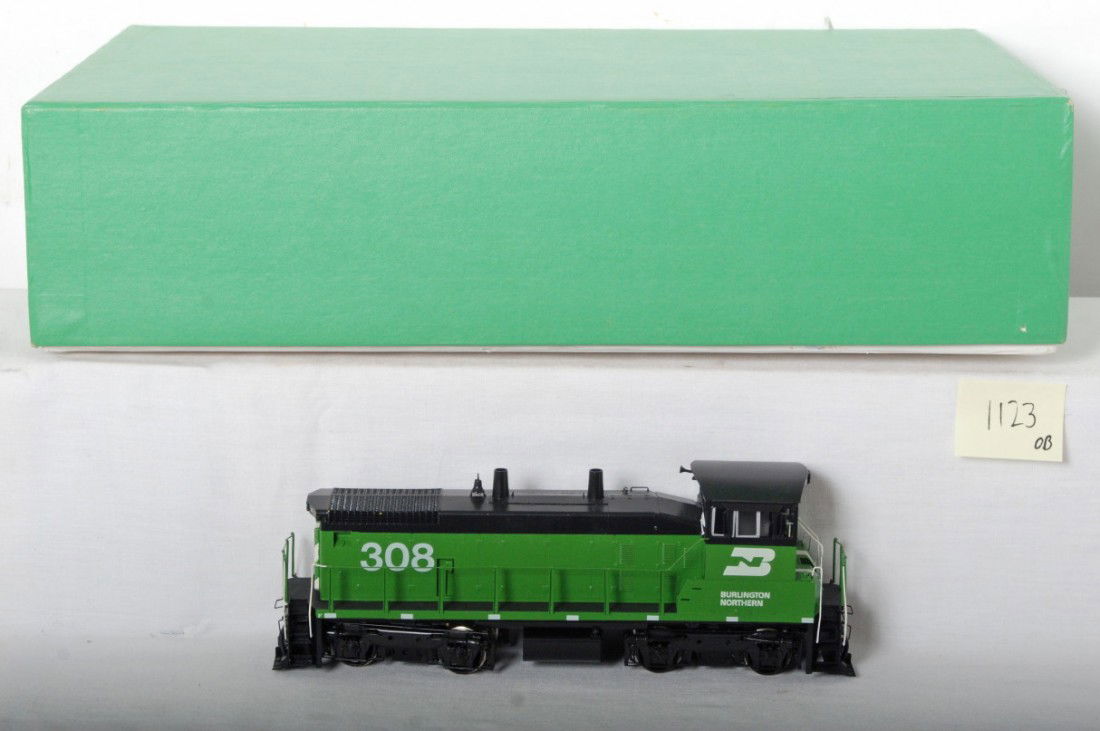 Overland brass Burlington Northern SW-1500: Overland O scale two rail brass Burlington Northern EMD SW-1500 diesel locomotive in OB. Item number is OMI-0295. Loco is C9-10 with no major signs of run time. Looks displayed only. OB has light wear