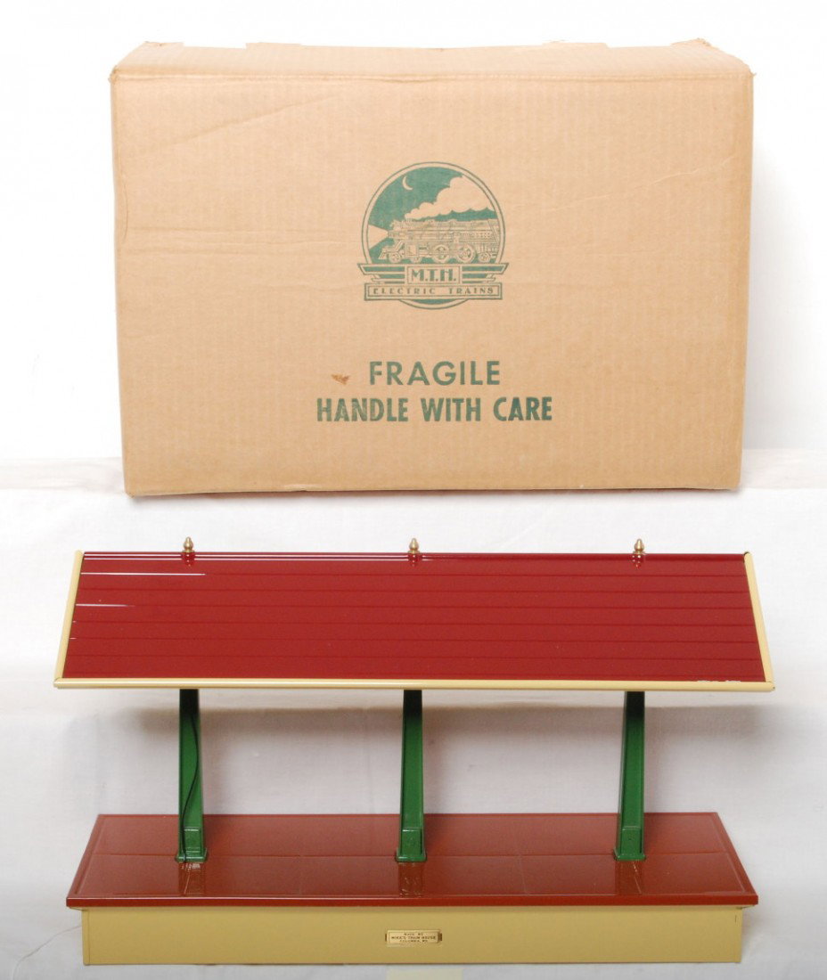 2 MTH Tinplate 155 freight stations: MTH modern standard gauge tinplate 155 cream freight stations. One station is factory wrapped in OB C9-10. The second has no box and is C8 condition, one small paint chip on the edge of the roof.
