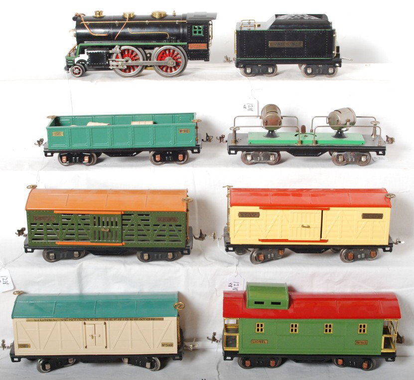 Lionel 384-E, 513, 514, 512, 514R, 517, 520: Lionel prewar standard 384-E steam locomotive and six freight cars. Loco has been restored to C7-8. Freight cars include 514 boxcar, 513 stock car, 512 gondola with wooden barrels, 514R refrigerator, 
