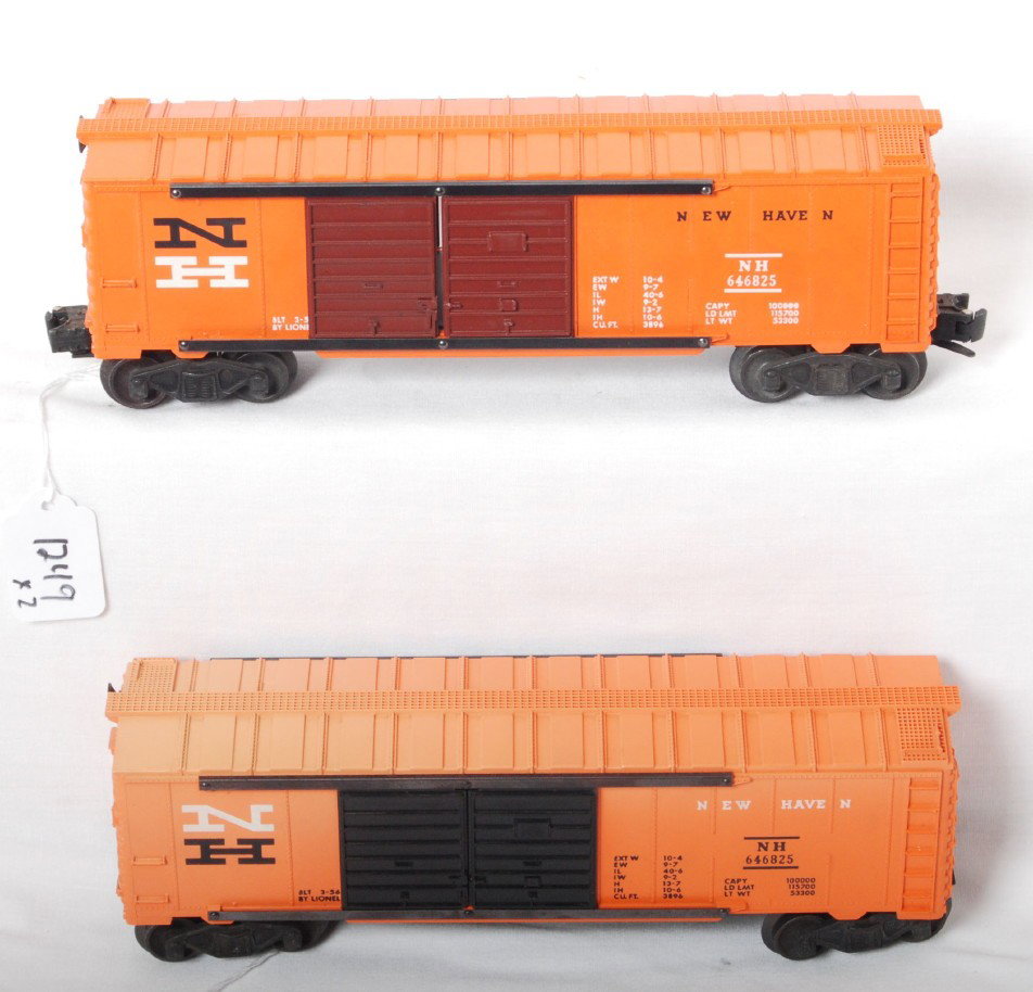 Two variations of Lionel 6468-25 NH boxcars: Postwar Lionel O ga. 6468-25 New Haven boxcar, one with Tuscan doors black N and other with black doors and white N, black door car has fading to roof of car, O/W cars are C7 area.