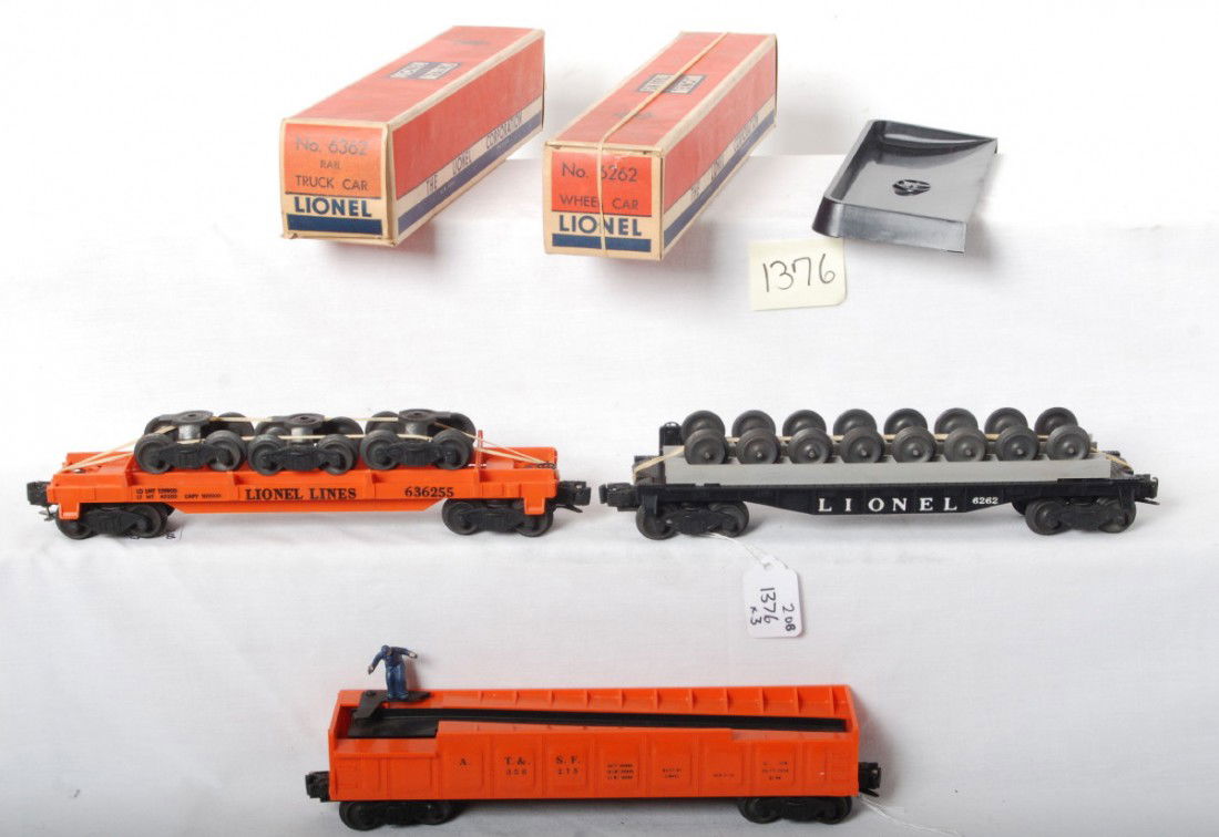 Lionel 6262 in OB, 6362 in OB, 3562-75, 160: Postwar Lionel O ga. 6262 rail truck car with matching unrun load, 6362 wheel car with unrun load, and 3562-75 A.T.S.F. barrel car with 160 bin. Trains are unrun C7-9. 6262 box is missing flaps, very