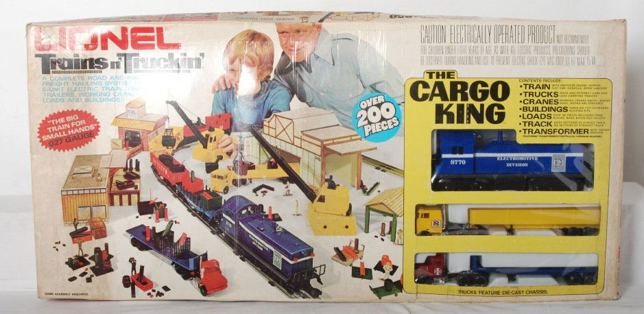 Lionel The Cargo King 200 Piece Set 1761: Lionel modern O gauge 1761 Trains n TruckinÕ Cargo King set. Set is sealed C10. but box has weight damage to the sides and some dirt on the set box.