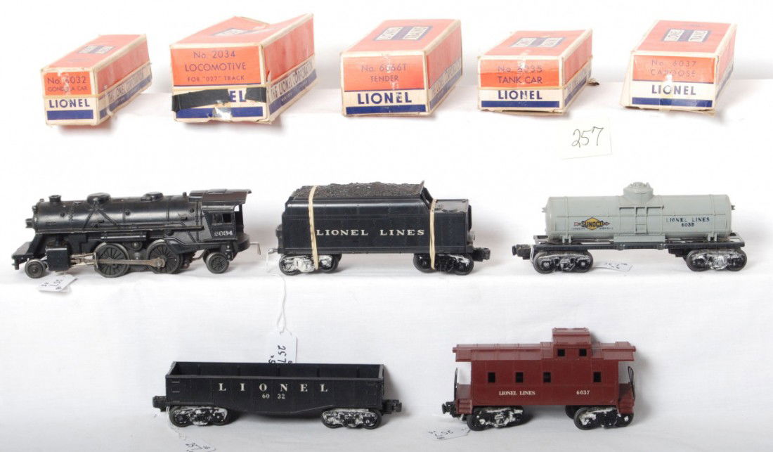 Lionel semi-Scout 2034, 6066T, 6032, 6035, 6037 in: Postwar Lionel O gauge semi-Scout steam freight train in original boxes with 2034 steam locomotive, 6066T tender (shell has broken screw mounts), 6035 Sunoco tank, 6032 gondola, and 6037 caboose, trai