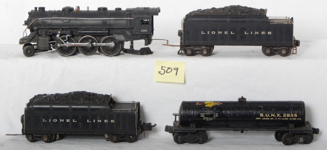 Lionel 224E, 2224W, 2224W, 2855: Prewar Lionel O gauge 224E steam locomotive, two 2224W whistle tenders (one missing whistle), 2855 Sunoco tank (missing trim). Please view the photos of the items in this lot, the items are sold as is