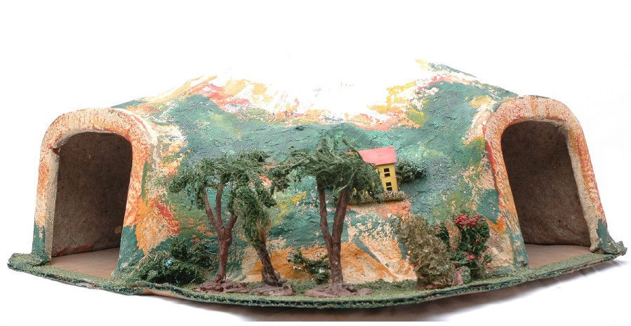 Lionel Prewar no. 123 Tunnel LIKE NEW: Lionel prewar O gauge no. 123 tunnel. The tunnel has bright colors and all landscaping and trees are fully intact. The base of the tunnel has a warp. Other than the warp, the tunnel is C8.