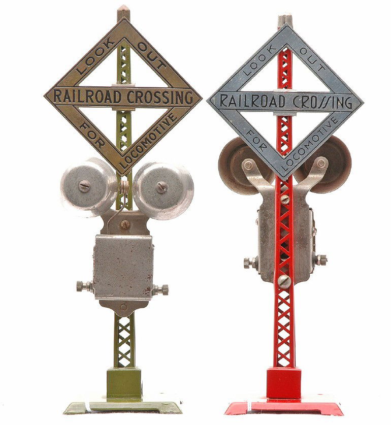 Lionel Accessories two 069 Warning Bell Signals: Lionel prewar O gauge accessories including; 069 red electric warning bell signal with nickel sign and finial and a 069 olive green electric warning bell signal with brass sign and finial. Both signal