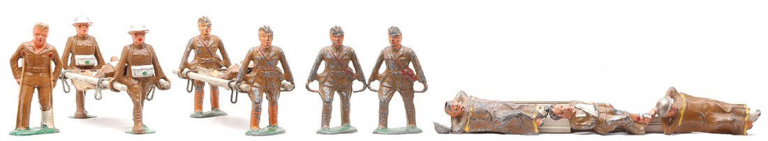 Manoil Barclay Medical Military Figures Stretcher: Manoil and Barclay medical military figures including; two stretcher parties, three laying wounded soldiers, two stretcher bearers and soldier on crutches. The figures range in condition from like new
