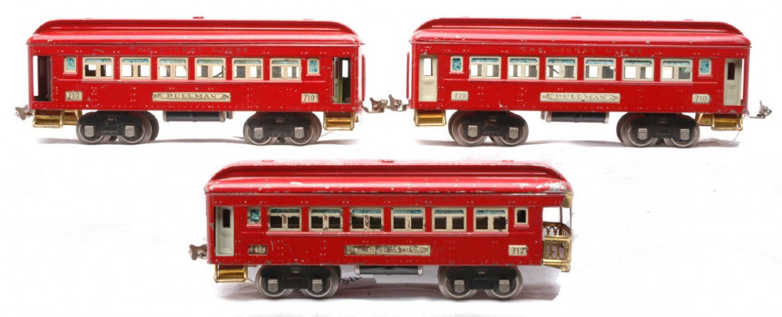 Lionel Prewar Red Passenger Cars 710 710 712: Lionel prewar O gauge red passenger cars with ivory inserts, four wheel trucks and nickel journals; two 710 Pullmans and a 712 observation. The cars are C5.