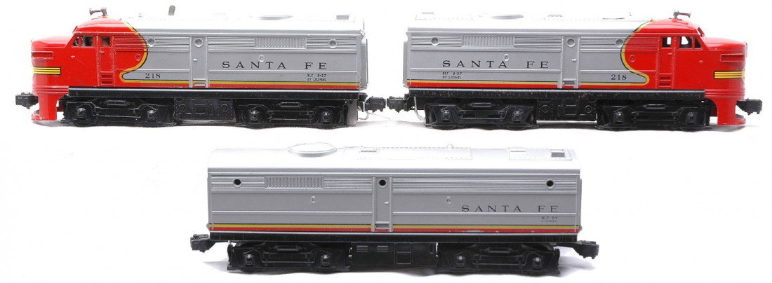 Lionel 218 SF Alco AA Diesels 218C SF Alco B Unit: Lionel postwar 218 Santa Fe Alco AA diesel units and a 218C Santa Fe Alco B diesel unit. Both nose decals on the AA units are intact and the pilot skirt on the power A unit has a repaired crack. The A