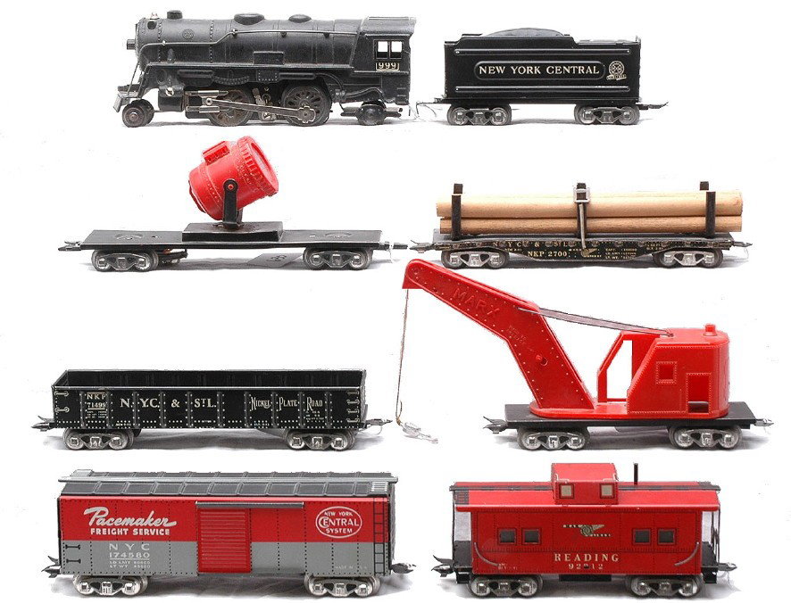 Marx Lithographed NYC Freight Set: Marx lithographed NYC freight set including; 999 black 2-4-2 steam loco, 951 New York Central tender, 2700 N.Y.C. & St.L Nickel Plate Road flatcar with wood load, searchlight car with red plastic ligh
