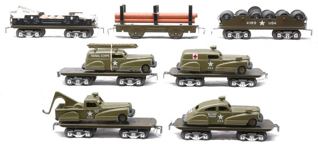 Marx Freight 4-Flatcars Army Vehicles 3-Flatcars: Marx freight cars reproduction by Marx Trains including; four flatcars with Army vehicles, 4199 Army flat with six sets of wheels and an Army flatcar with shells and trench bags. Also included is a fo
