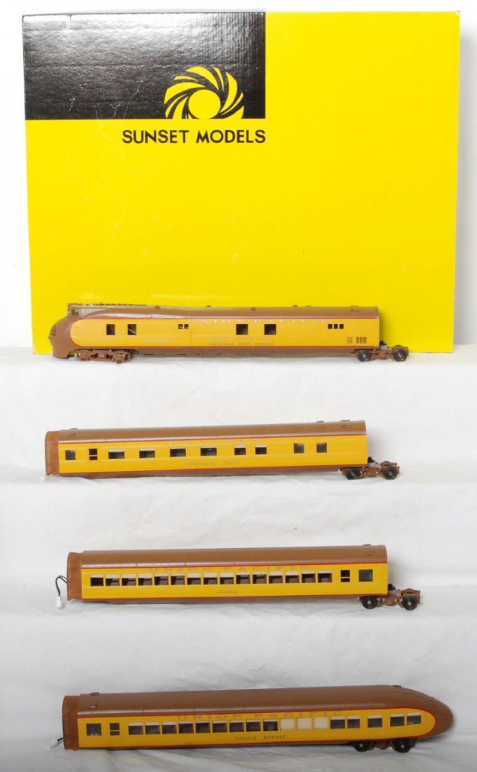 Sunset brass Union Pacific M-10000: Sunset brass O scale two rail Union Pacific M-10000 streamliner set in OB. Includes powered loco and observation along with two coaches. Locos and cars are C8-9 with run time. Locomotive original box